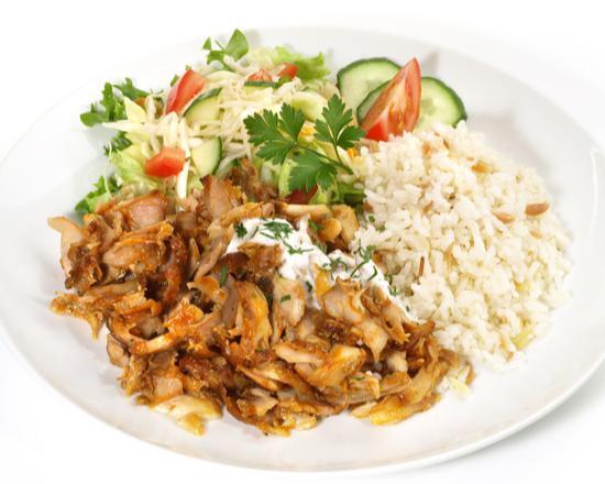 Halal Lamb and Chicken Over Rice and Salad · Halal lamb and chicken vegetables over a bed of rice.