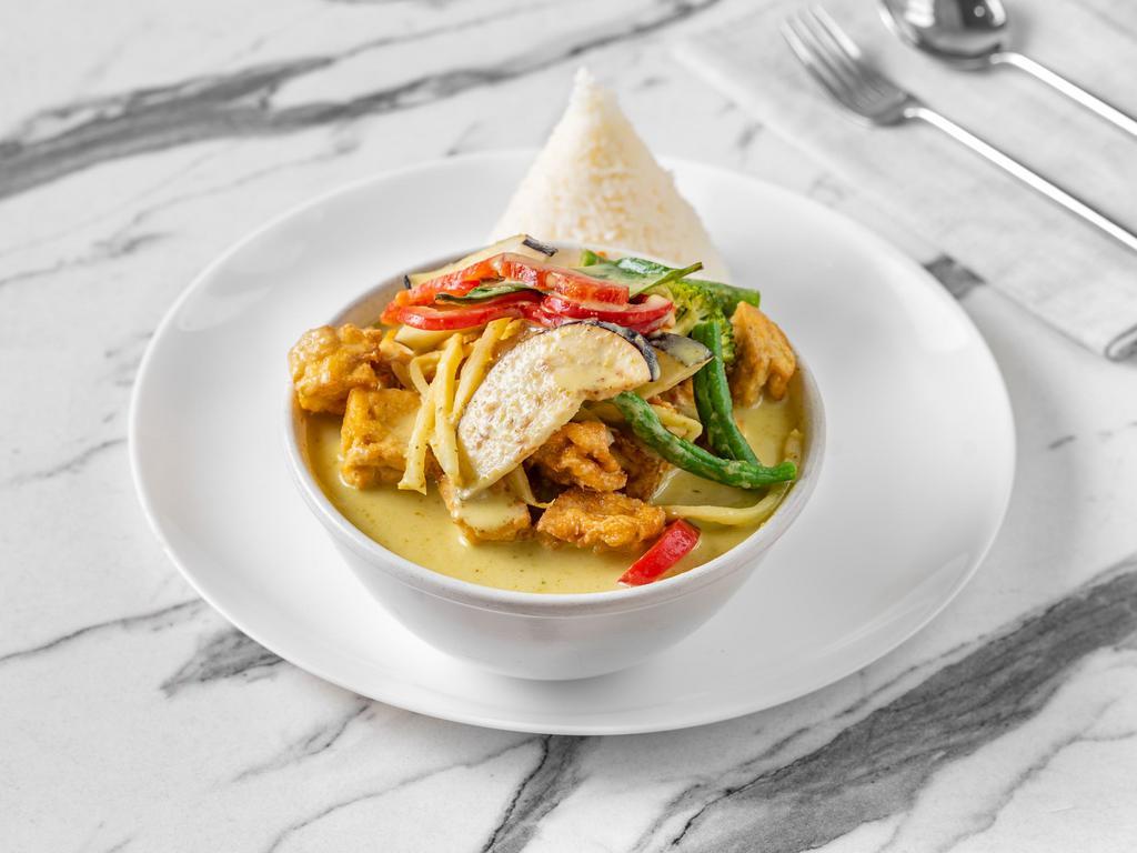 Vegan Green Curry · Authentic Thai green curry sauce with eggplant, bamboo shoots, string beans, bell peppers and basil leaves with coconut milk. Served with rice. Spicy. Gluten free.