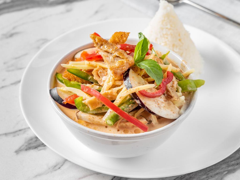 Vegan Red Curry · Smooth and creamy Thai red curry sauce with eggplant, bamboo shoots, string beans, bell peppers and basil leaves with a coconut milk. Served with rice. Spicy. Gluten free.