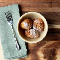 Beignet · Puff puff cup. Fried donut hole served plain, or with power sugar or chocolate ganache.
