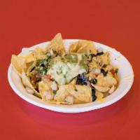 Nachos · Tortilla chips topped with choice of filling, beans, queso and salsa. Toppings include pico ...