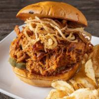 Smoked Pulled Pork Sandwich · Frizzled onions and pickles.
