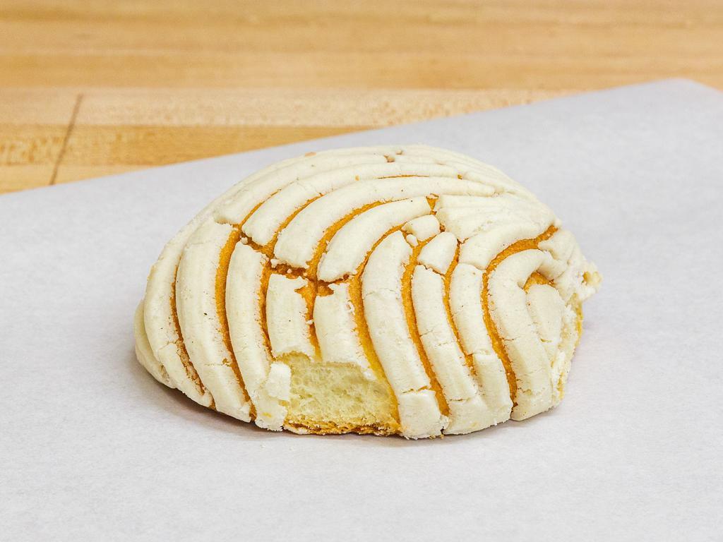 Concha de Vainilla · The name means shells and is perhaps the most popular of the Mexican pan dulce. This pillowy soft, brioche texture rounded breads are topped with a vanilla buttery-sugar flavored coating which typically has a seashell-like pattern.