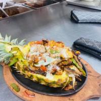 Pineapple Loca Fajita · Steak, chicken and shrimp cooked with pineapple, bell peppers and onions, topped with cheese...