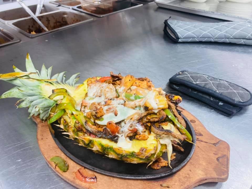 Pineapple Loca Fajita · Steak, chicken and shrimp cooked with pineapple, bell peppers and onions, topped with cheese dip.