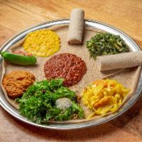 Yetsom Beyaynetu Plate (serves 1-2) · Misr wot - spicy red lentils, atkilt - market vegetables, kik alicha - yellow split peas, go...