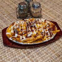 Fat Boy Fries · Crispy fries layered with melted mozzarella, American and cheddar Jack. Topped with crumbled...