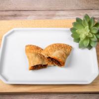 Chipotle Beef Empanada · Carne chipotle. Ground beef, smokey chipotle peppers, sweet peppers, onion and garlic. Hot.