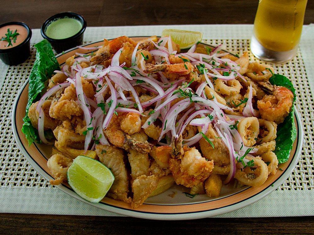 Mini Jalea · Breaded shrimp, calamari, fish and fried cassava yuca topped with marinated red onion and lime juice on top.