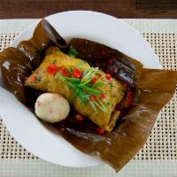 Tamal · Traditional Colombian dish stuffed with meat, chicken, pork, potato, wrapped in plantain lea...