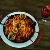 Paella Valenciana · Seafood and meat combination, shrimp, clams, mussels, calamaris, chicken and Spanish sausage...