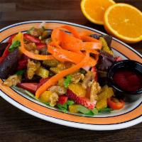 Ensalada Raices · Mesclun salad, caramel walnuts, cherry tomatoes, oranges and red onions served with a delici...