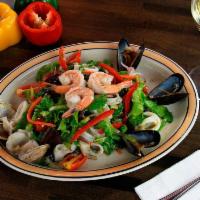 Ensalada de Mariscos · Calamari, shrimp, salmon, mussels and clams mixed with fresh vegetables.