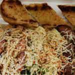 Way Way New Orleans Style Pasta with Garlic Bread · Fettuccine tossed in delicious freshly homemade Alfredo sauce, grilled sausages, chicken, an...