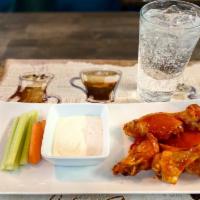 8 Buffalo Wings · Natural, lemon pepper, and buffalo. Served with carrots and celery. Naturales pimienta limon...
