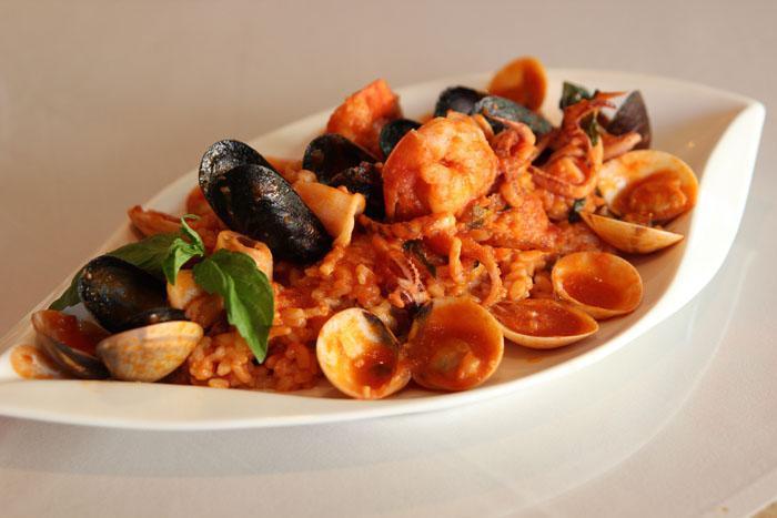 Risotto al Pescatore · Rice with shrimp, calamari, mussels and clams in a red or white sauce. 