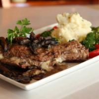 Costatelle D'Agnello · Grilled lamb chops served with a side of mashed potatoes. 