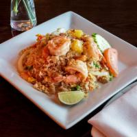 Pineapple Fried Rice · Shrimp fried rice with pineapples, cashew nuts, onions, tomatoes, carrots, peas and eggs. Ca...