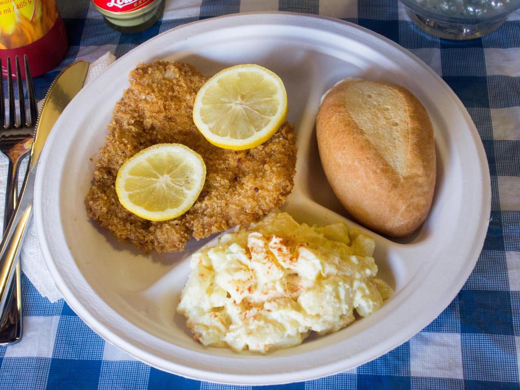 Wiener Schnitzel Plate · Breaded pork cutlet topped with lemon slices. Served with your choice of cold potato salad or warm red cabbage.