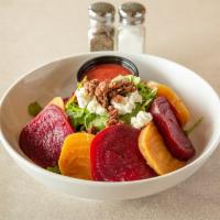 Roasted Beet Salad · Organic baby arugula, pecans, roasted red beets and goat cheese with a raspberry vinaigrette...