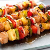Chicken Kebab Skewer · Marinated chicken cubes skewered and grilled. Comes with bun and side of BBQ sauce.