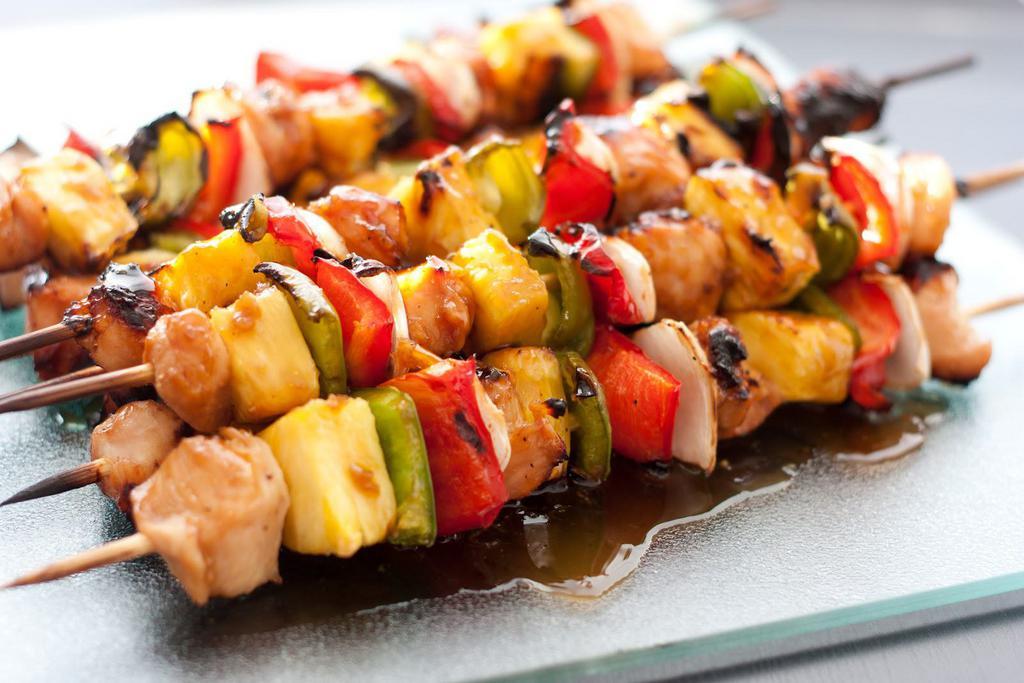 Chicken Kebab Skewer · Marinated chicken cubes skewered and grilled. Comes with bun and side of BBQ sauce.