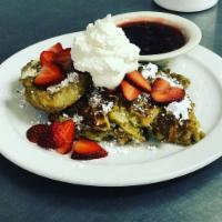 Croissant French Toast · 4 pieces of buttery croissant french toast served with seasonal fruit, lingonberry syrup and...