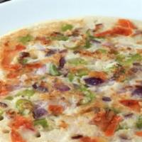 Tomato Uttapam · Uttapam is a thick pancake, with toppings cooked right into the batter. Uttapam is sometimes...