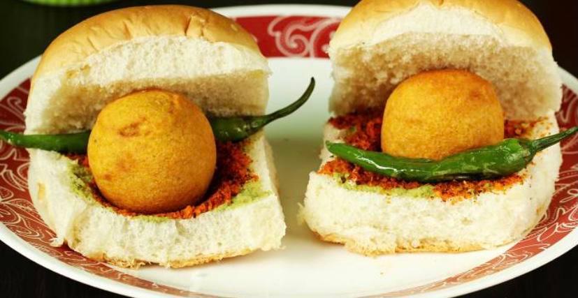 Vadapav (2piece) · The dish consists of a deep fried potato dumpling placed inside a bread bun (pav) sliced almost in half through the middle. It is generally accompanied with one or more chutneys.