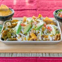 Sancho Nachos · Fried tortilla chips topped with chile con queso, refried beans, mozzarella cheese, avocado,...