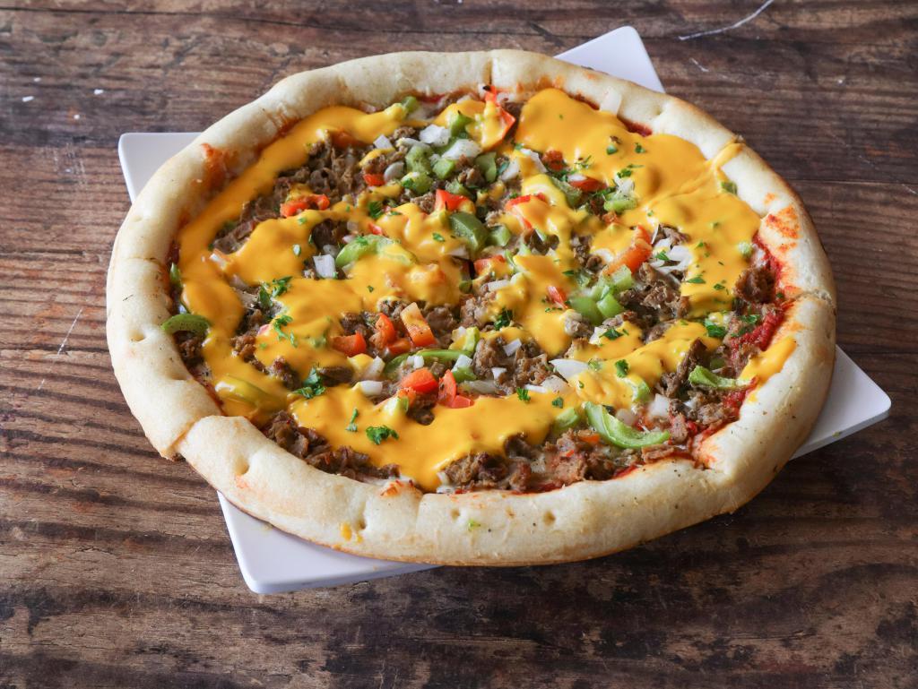 Chubby's Philly Cheesesteak Pizza · Rib eye steak, olive oil, Classico sauce, mozzarella, green peppers, red peppers, onions and cheese whiz drizzle.