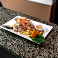 Ceviche Mixto · Sliced fish and seafood marinated in lime juice and hot pepper.