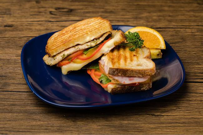 Canadian Bacon and Chicken Panini · Seasoned chicken on Italian bread pressed with sweet pineapple rings, crisp red bell pepper, Canadian bacon and fresh basil.