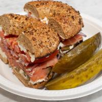Nova Scotia Smoked Salmon Bagel · Made with fresh sliced smoked nova scotia lox, cream cheese, topped with capers, tomatoes, a...