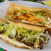 Chicken Quesadilla · Two warm grilled flour tortillas filled with cheese, fresh lettuce, Cotija powder cheese, an...