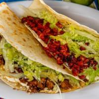 Chorizo Quesadilla · Two warm grilled flour tortillas filled with cheese, fresh lettuce, Cotija powder cheese, an...