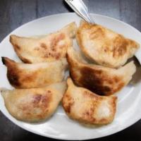Pot Stickers · 6 pieces. Spice-infused ground pork, napa cabbage and pan-fried to a golden brown.