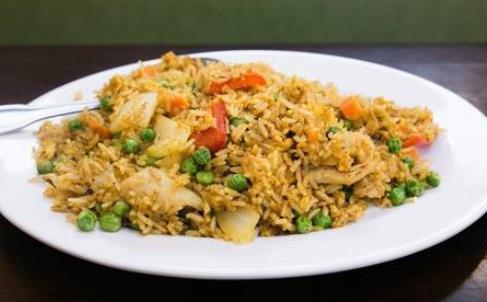 Curry Chicken Fried Rice · Chicken breast, red bell peppers, white onion, peas, carrots, egg, and house-blend curry spices.