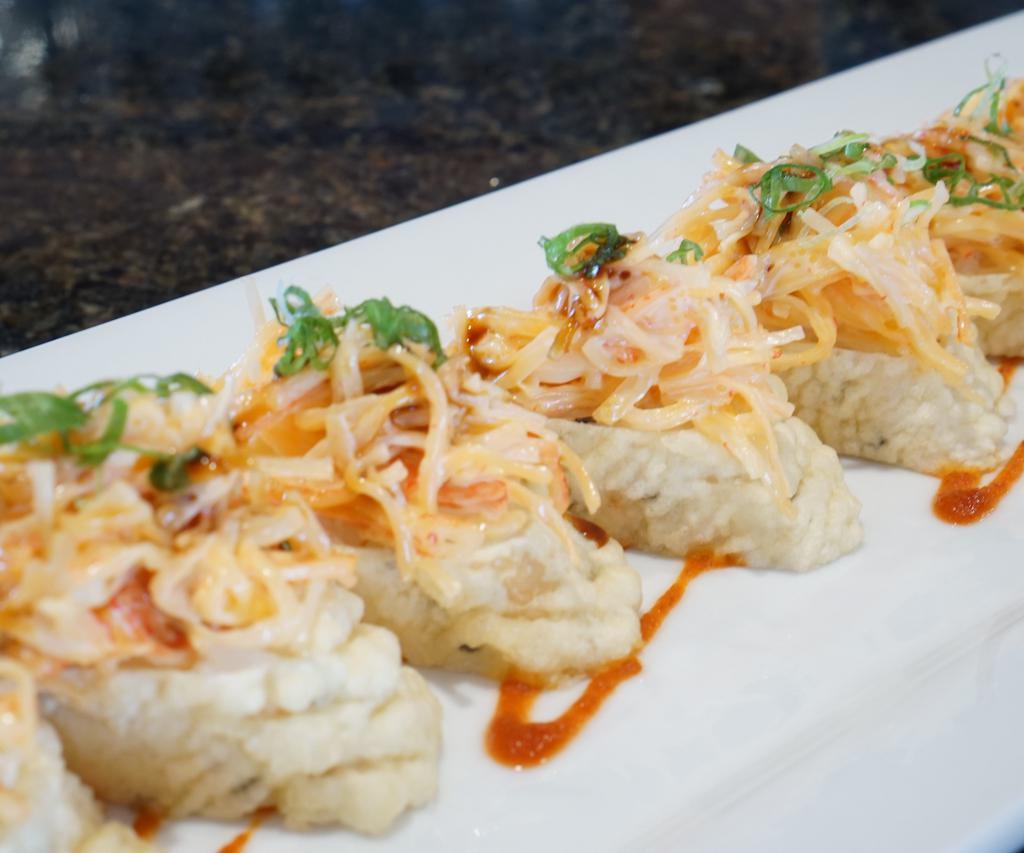 Vallarta Roll · Salmon and cream cheese; fried; topped with spicy crab, green onion, and unagi sauce.
