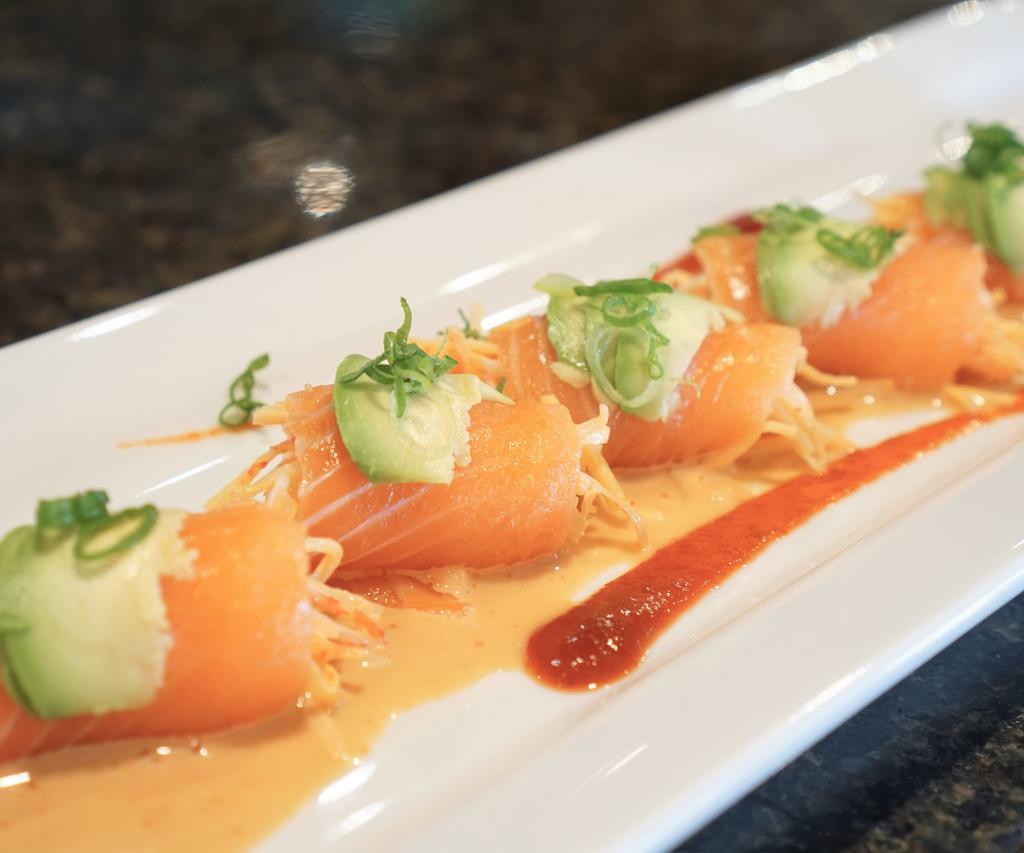 Salmon Enchilada Roll · Spicy crab meat rolled with smoked salmon; topped with avocado, green onions and miso sauce.