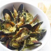 Mussels in Spicy Green Sauce · Mussels cooked with a spicy cilantro green sauce, served with toast.
