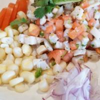 Peruvian Ceviche · Traditional Peruvian tilapia ceviche, served with avocado, corn, red onions,  and lemon juice.