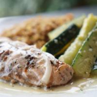 Salmon Steak · Grilled salmon covered with our creamy white wine sauce, served with two sides.