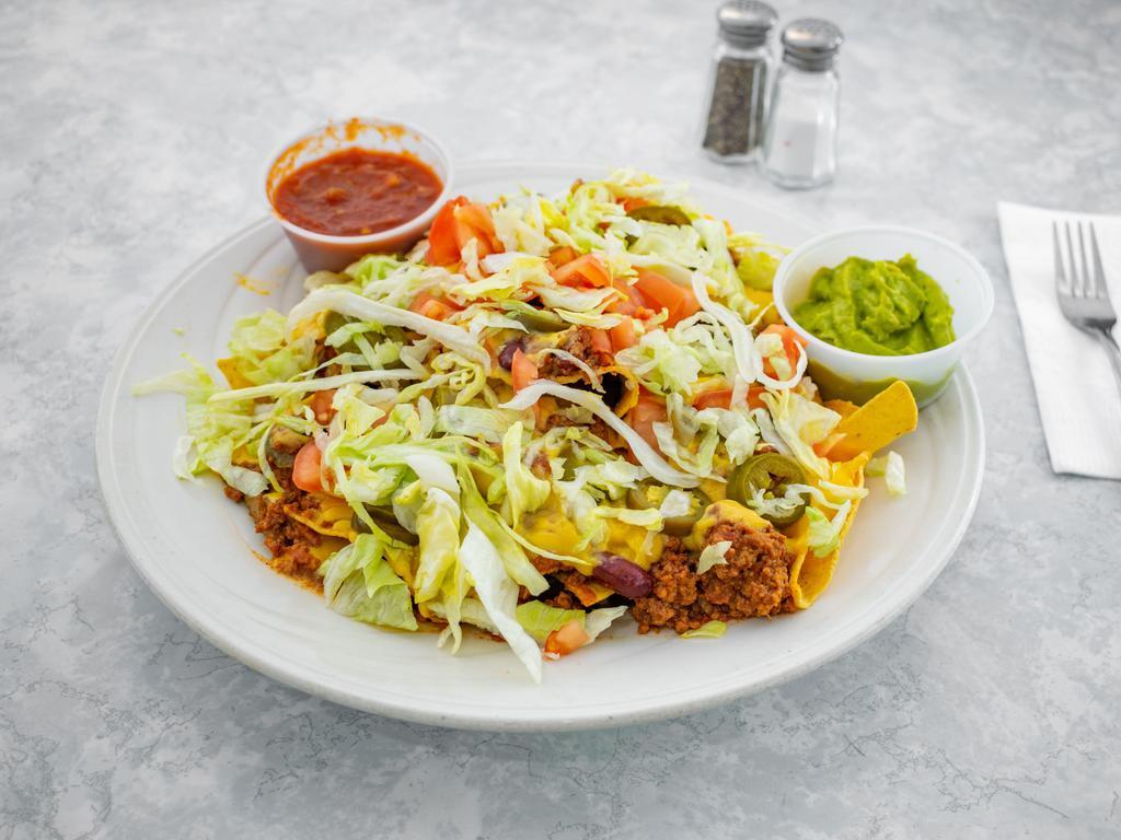 Ultimate Nachos · Piled high with melted cheeses, chili, diced tomatoes, jalapeno peppers, shredded lettuce, sour cream, salsa and guacamole.