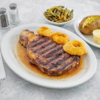 Broiled Rib Eye Steak · Served with onion rings.
