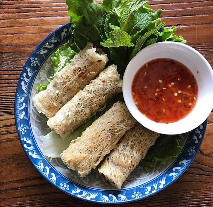 Crispy Spring Rolls · Served with ground pork, crab meat glass noodles, carrots and wood ear mushrooms, served with flavorful sweet, sour, and spicy dipping sauce, lettuce and fresh herbs to wrap.