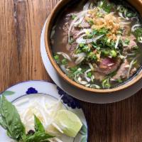 Classic Vietnamese Beef Bones Broth Pho · Served with rice noodles, slices of beef and beef brisket, bean sprout, Asian basil.
