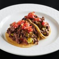 Tacos de Carne Asada · Grilled hanger steak, guacamole, pico de gallo, tomatillo salsa. Contains gluten.
