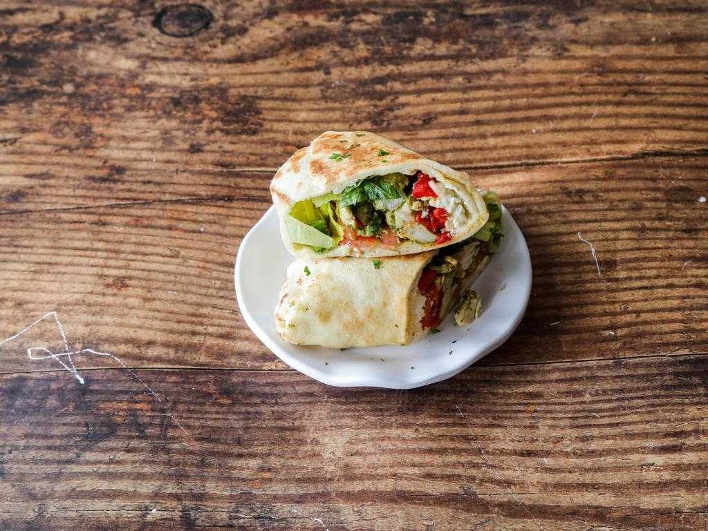 Chicken Pesto · Our Chicken Pesto Pita comes with Romaine, Roasted Red Peppers, Tomatoes, Onions, Feta Cheese and Greek Seasoning.