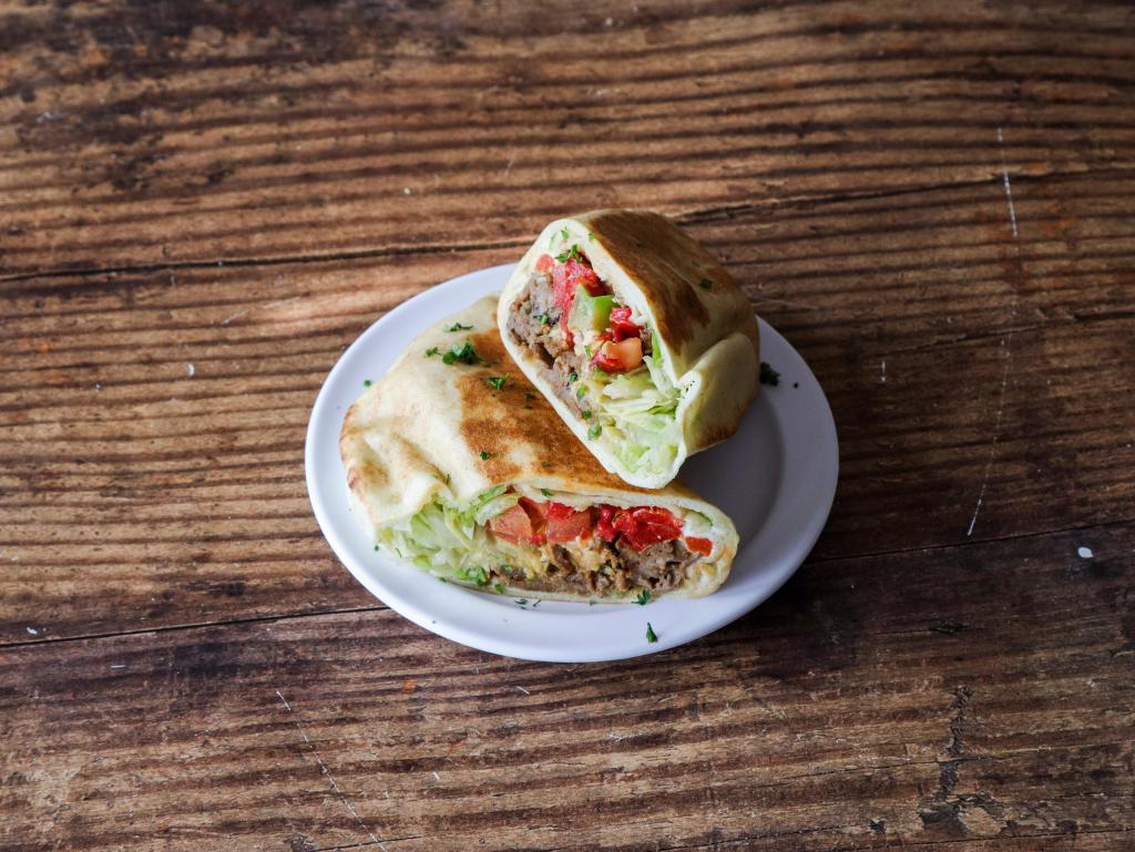 Steak Fajita · Our Steak Fajita Pita comes with Steak, Grilled Onions, Grilled Green Peppers, Shredded Lettuce, Tomatoes, Roasted Red Peppers, PepperJack Cheese, Ancho Chipotle Sauce, Sour Cream, and Mojito Lime Seasoning.